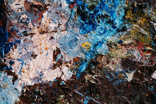 Colorful textured abstract paint surface with dynamic patterns and vivid hues.