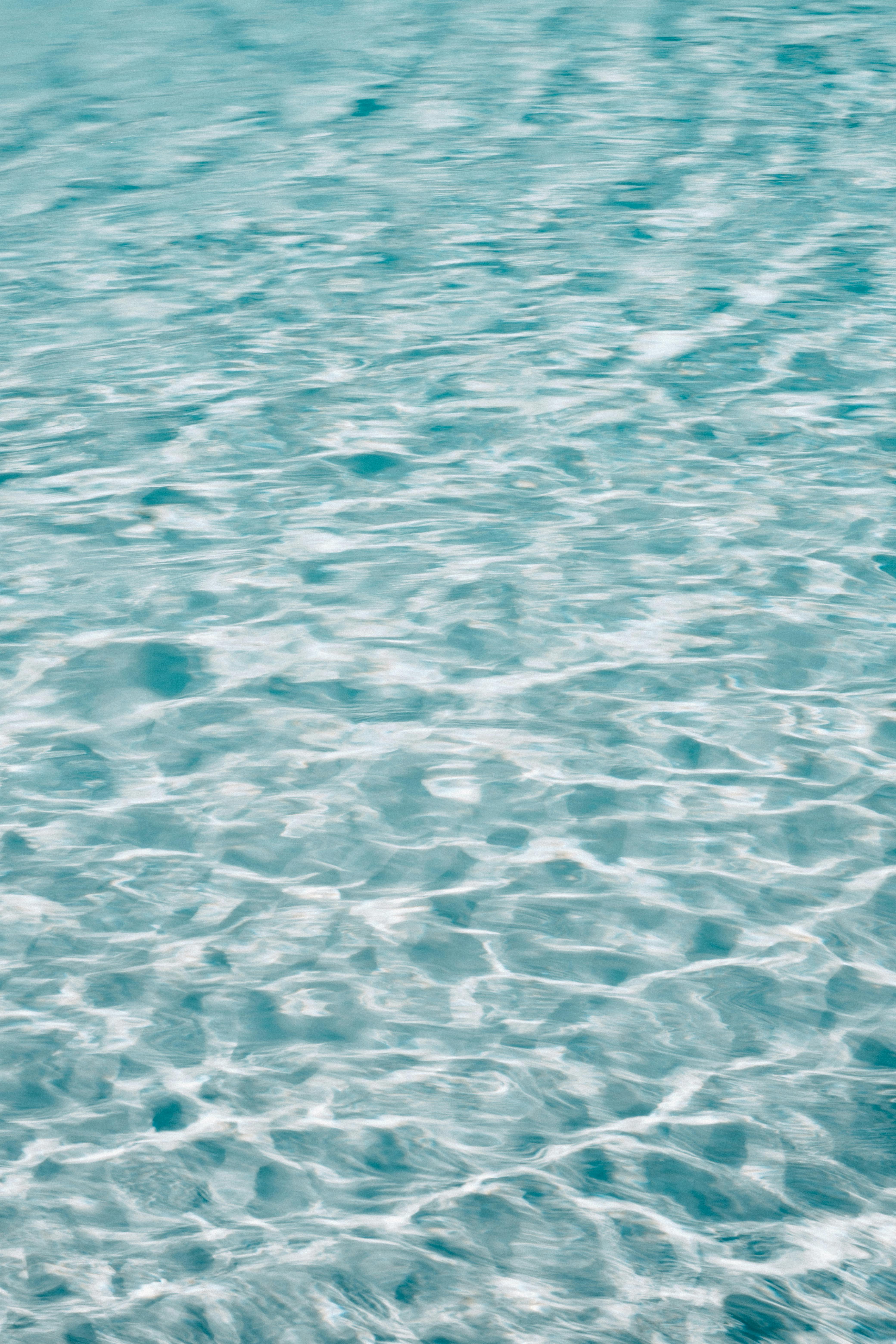 A serene view of turquoise ocean water with gentle ripples, capturing the essence of summer.
