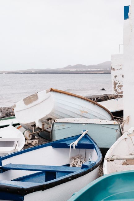 Vibrant rowboats on a tranquil seaside, perfect for a summer escape.