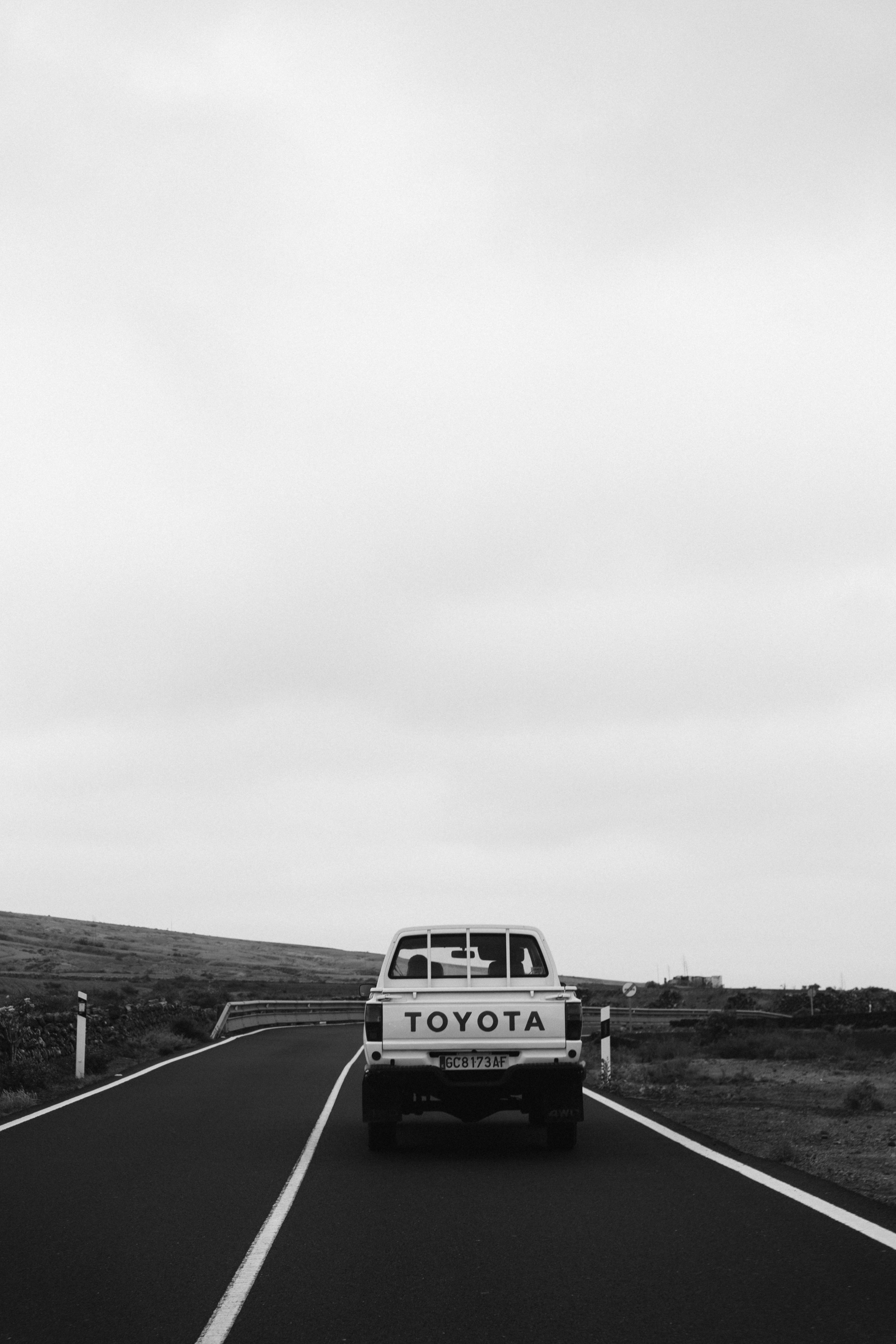 a truck driving down a road with a sign that says road to the north