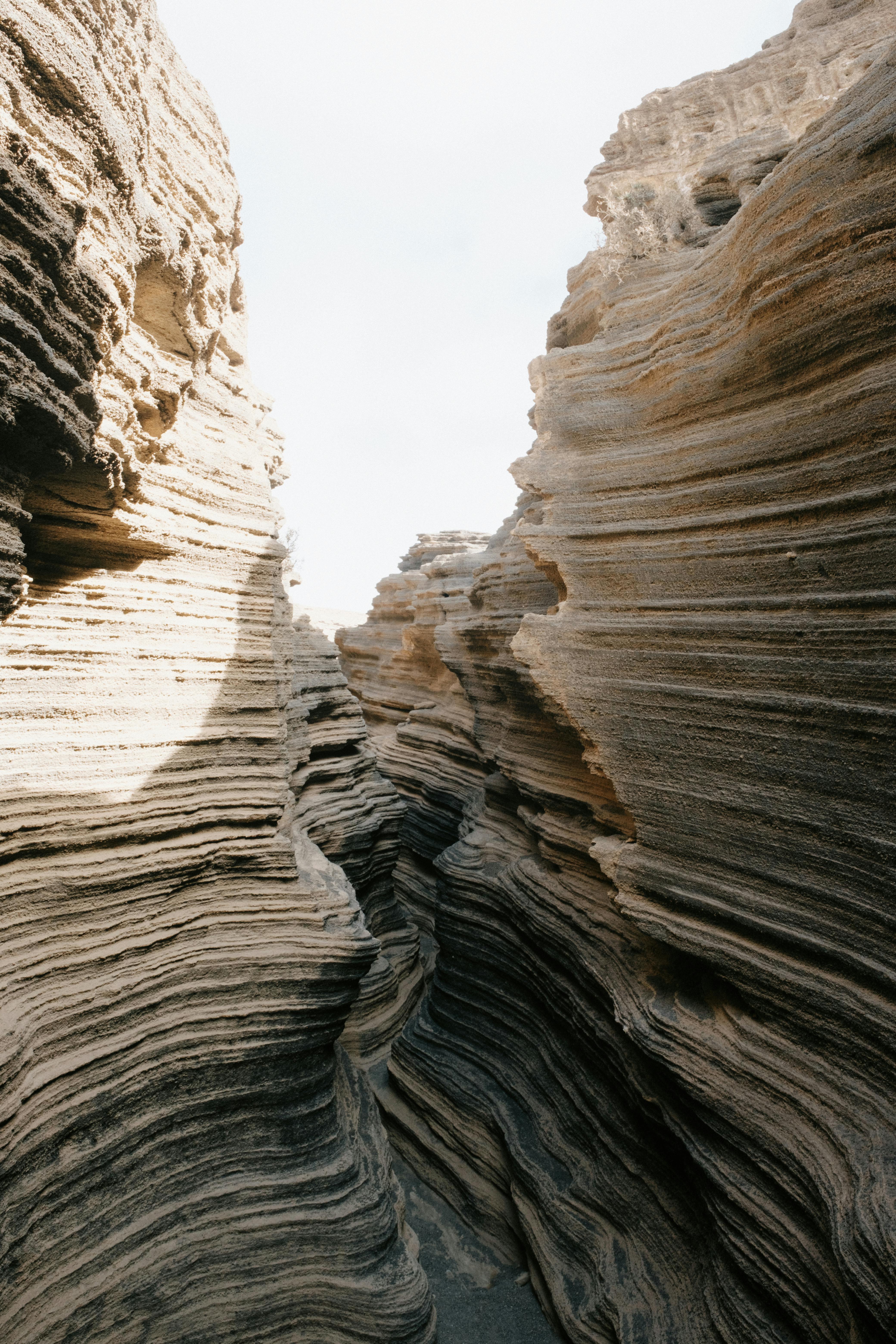 Capture the beauty of erosion and texture in this dramatic sandstone canyon landscape.