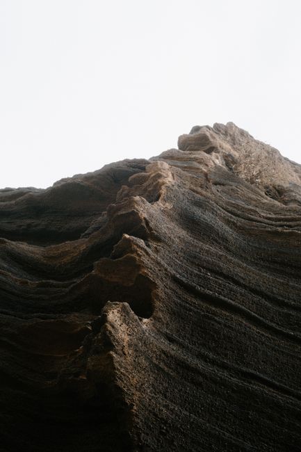 Close-up of a dramatic rock formation emphasizing texture and geological layers.
