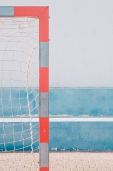 Minimalistic shot of a soccer goal with vibrant blue background. Perfect for sports or design themes.