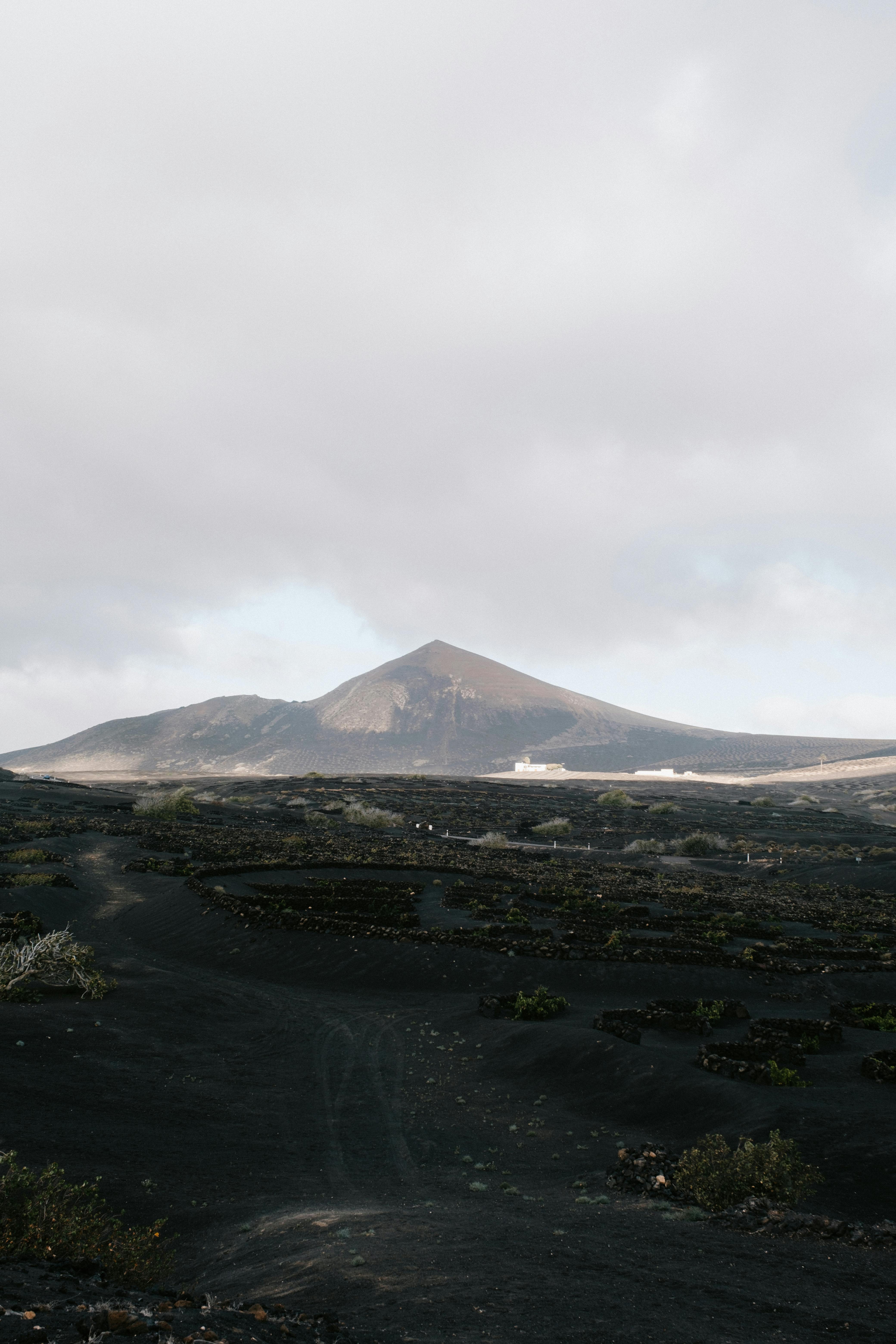 Explore a serene volcanic landscape under a moody sky, perfect for travel and adventure enthusiasts.