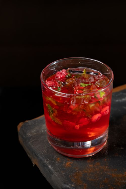Free Delicious strawberry and mint cocktail with ice cubes served in a glass, perfect for a refreshing summer drink. Stock Photo