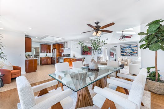 Bright and stylish open-concept living space featuring a minimalist dining area and cozy living room.