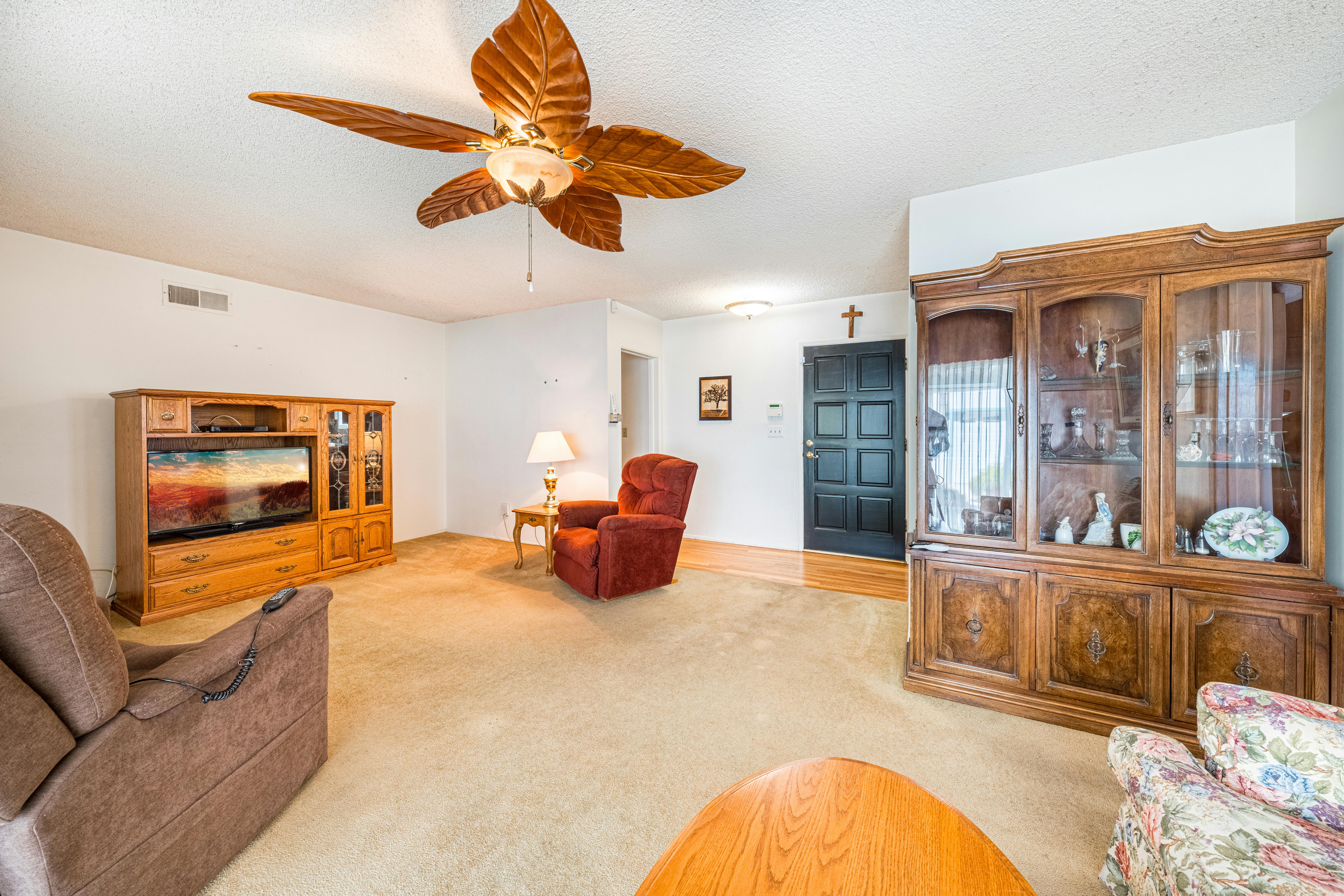Cluttered living room with traditional furniture and household items