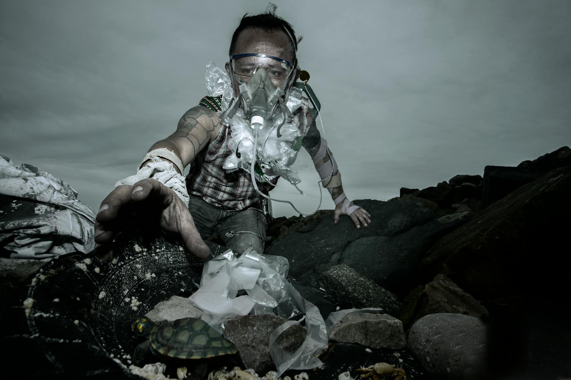 A Man Reaching for a Piece of Plastic while Diving