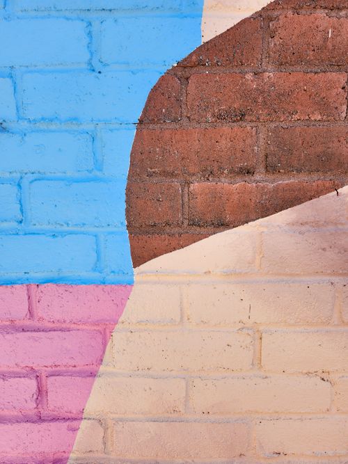 Free Abstract graffiti on a brick wall in Trois-Rivières, Québec, showcasing a mix of colors and textures. Stock Photo