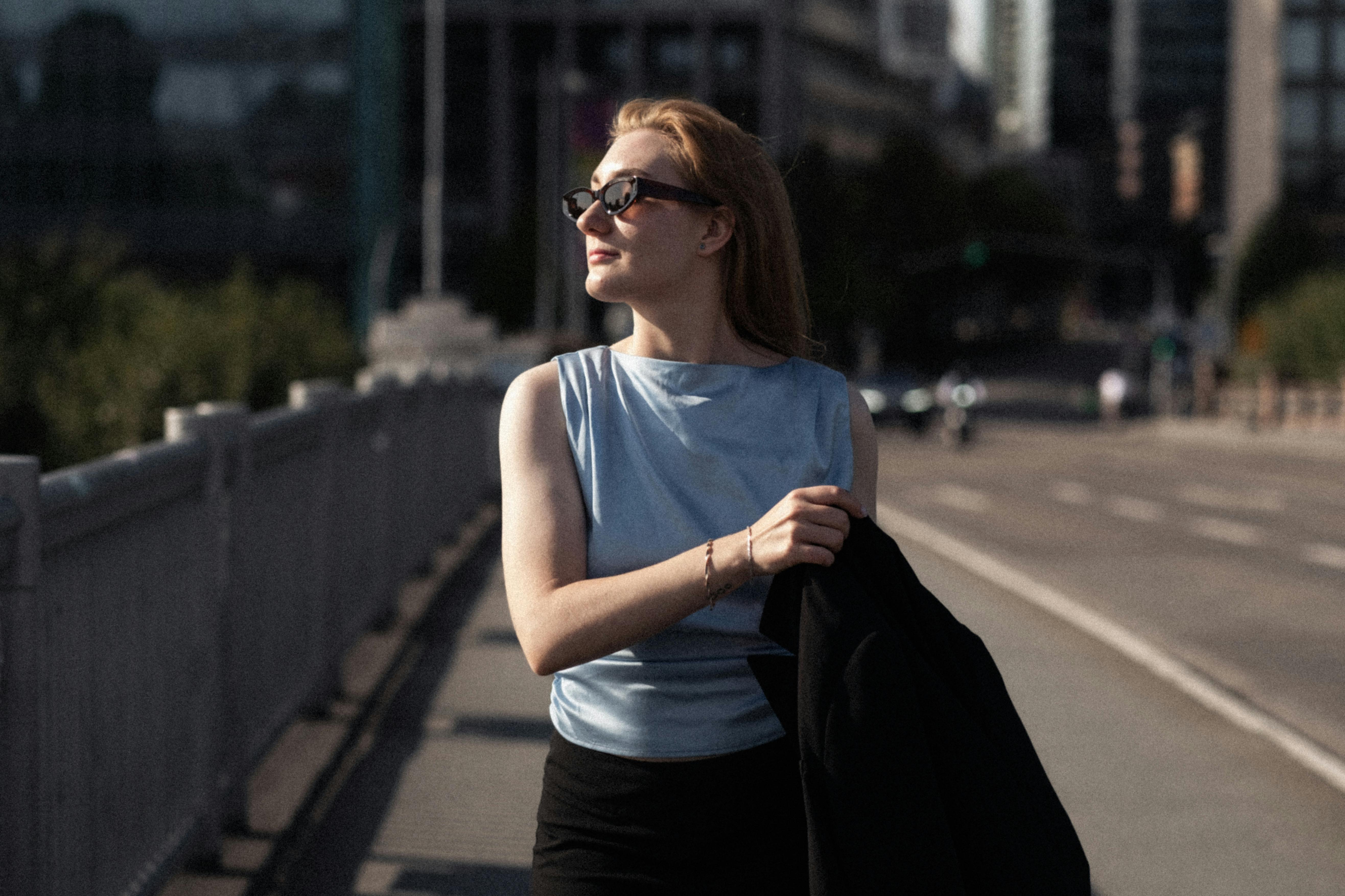 a woman in a business suit walking on a city street