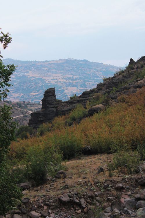 Free Explore a rocky hillside in autumn with a distant mountain view in daylight. Stock Photo