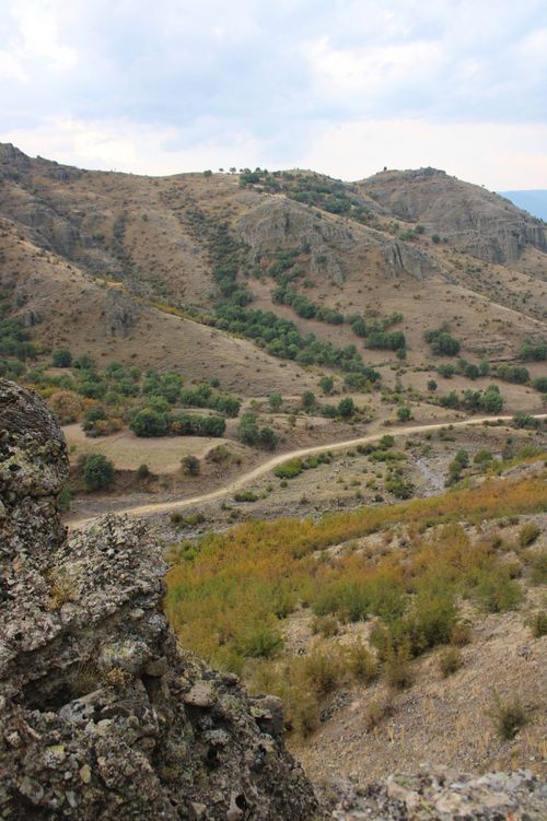 Free Explore the tranquil beauty of rocky hills and lush valleys under a summer sky. Stock Photo