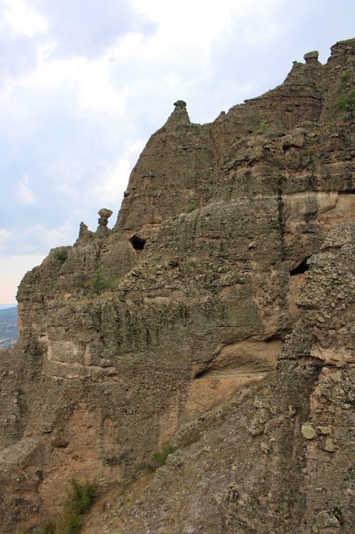Free Captivating view of ancient rocky cliffs against a dramatic cloudy sky, showcasing natural beauty and rugged terrain. Stock Photo