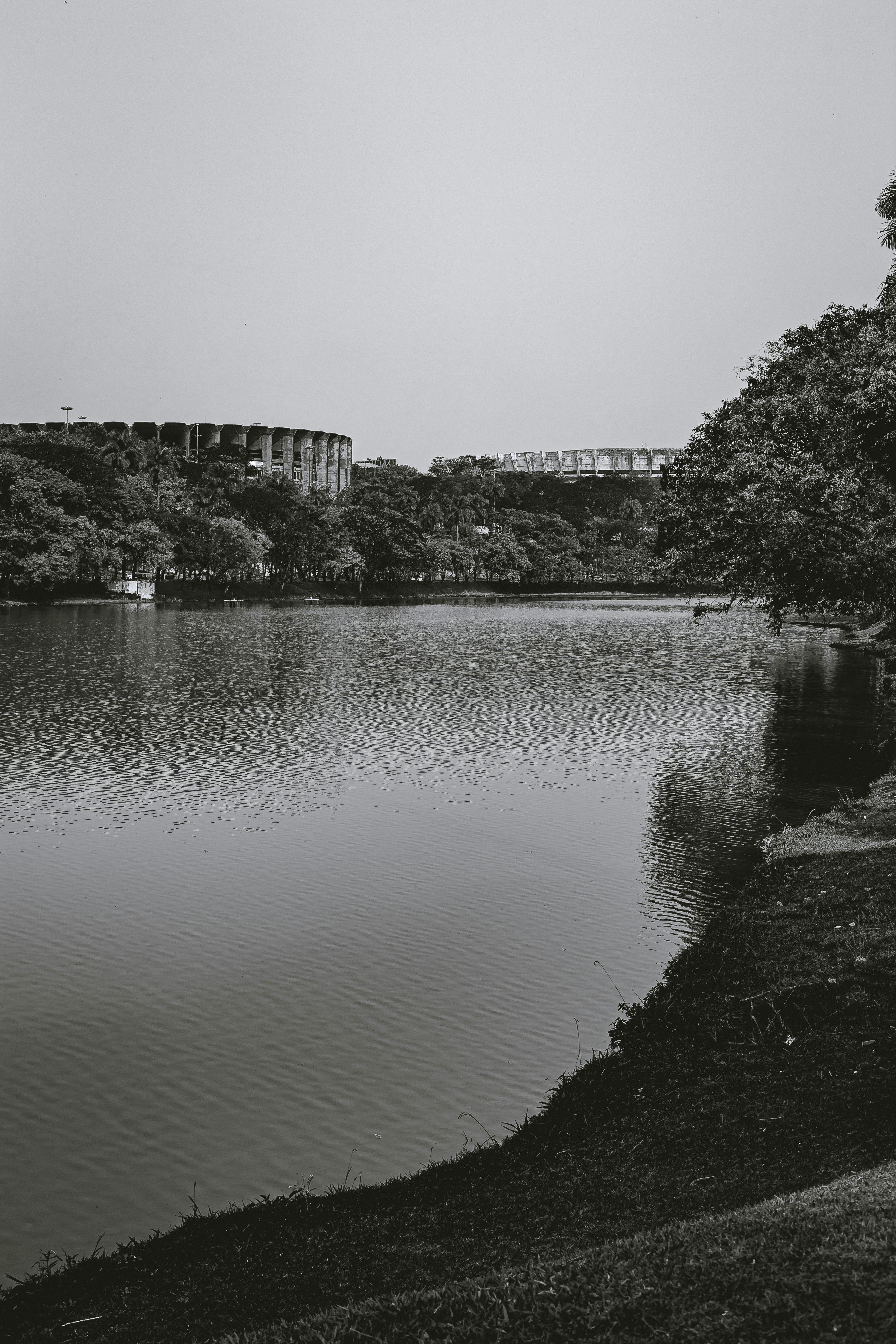 Scenic black and white view of Pampulha Lake and Mineirão Stadium in Belo Horizonte, Brazil.