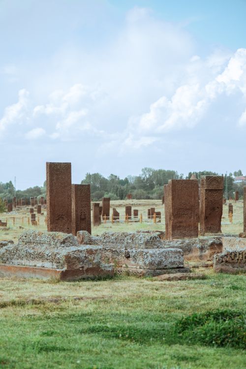 Free Explore timeless stone ruins in a serene, grassy landscape under a bright sky. Stock Photo