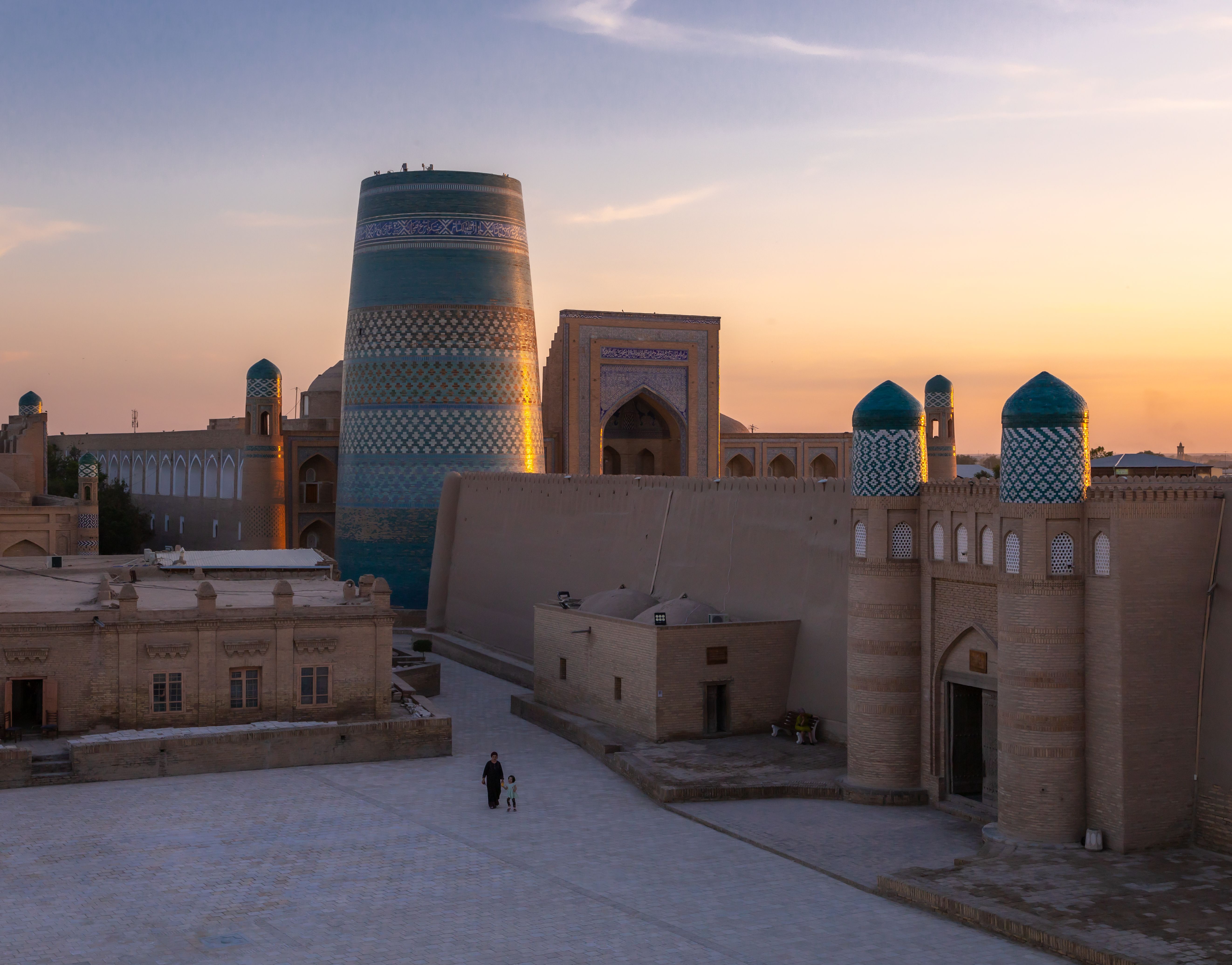 Capture of Khiva's historic Itchan Kala during sunset with the iconic Kalta Minor Minaret.