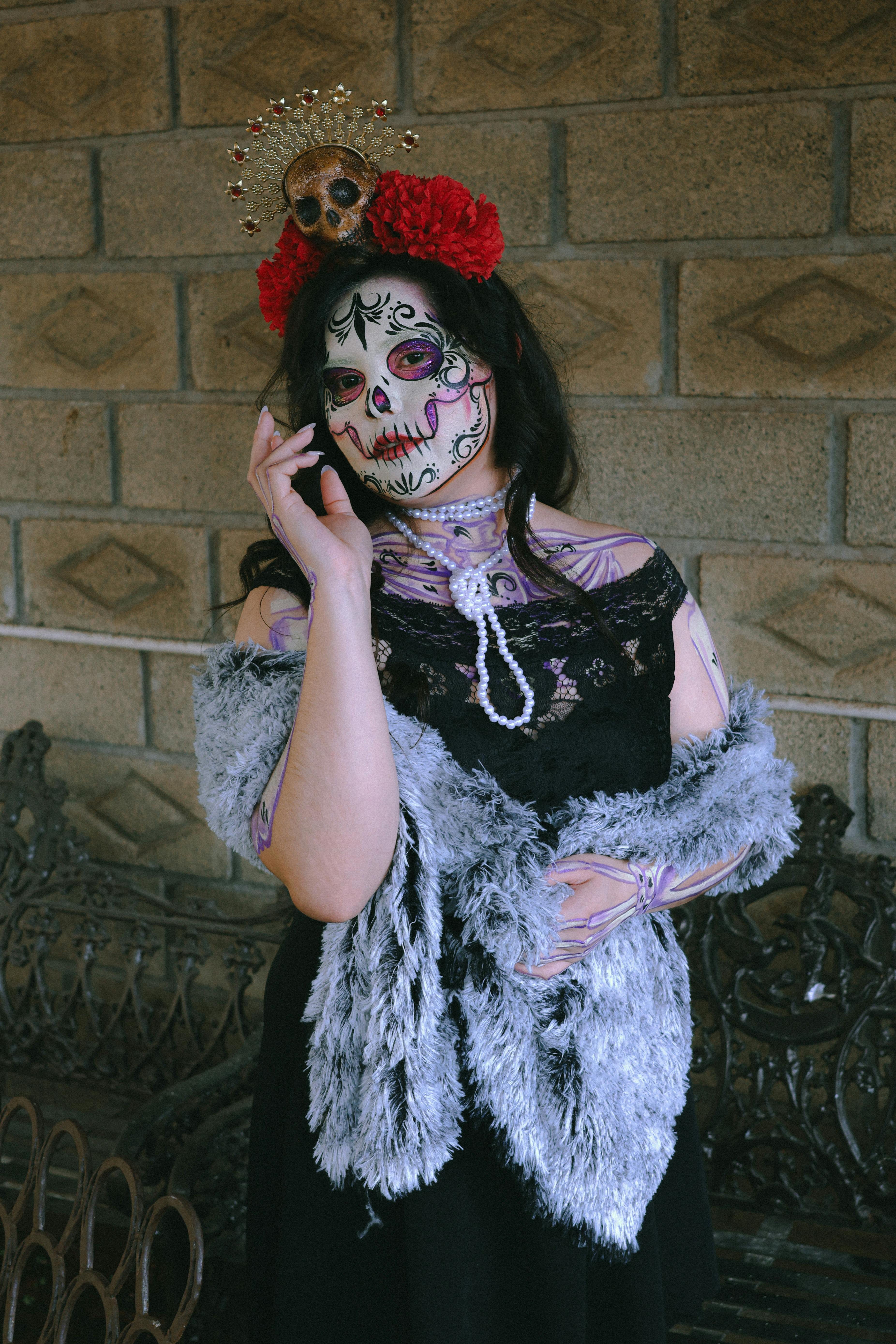 a woman dressed as a skeleton with a flower on her head