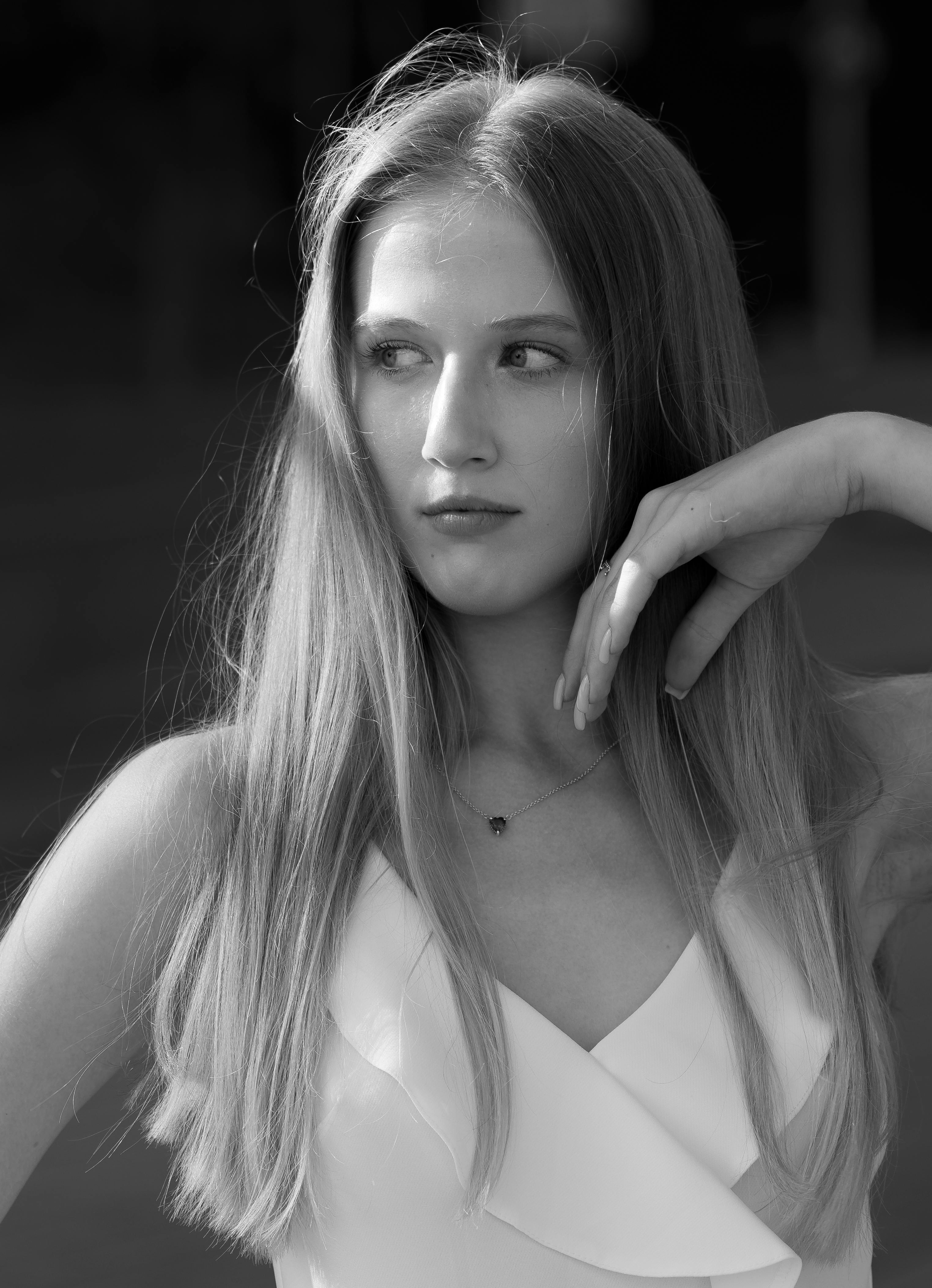 a woman with long hair posing for a black and white photo