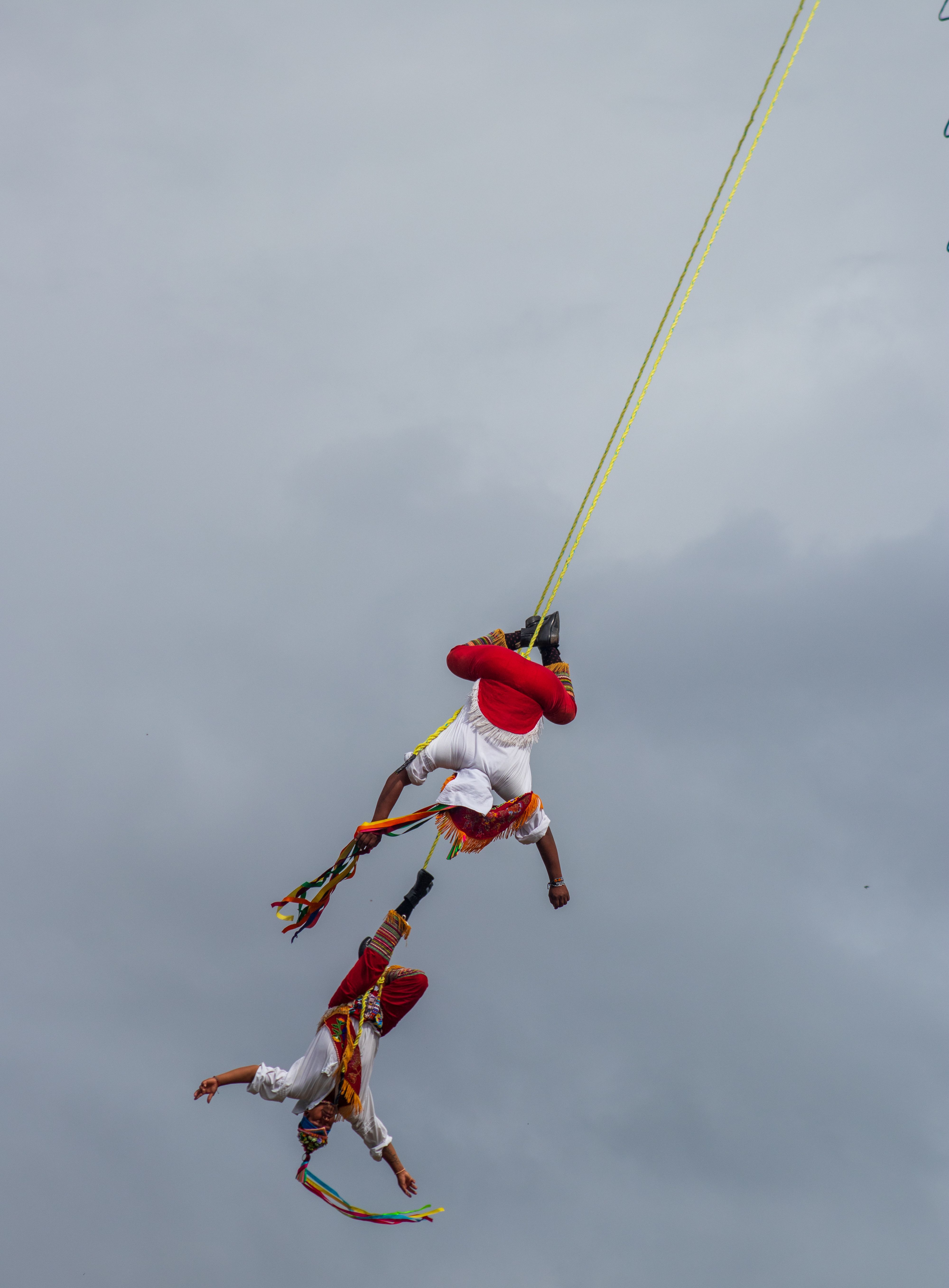 Two people are hanging from a rope in the air · Free Stock Photo