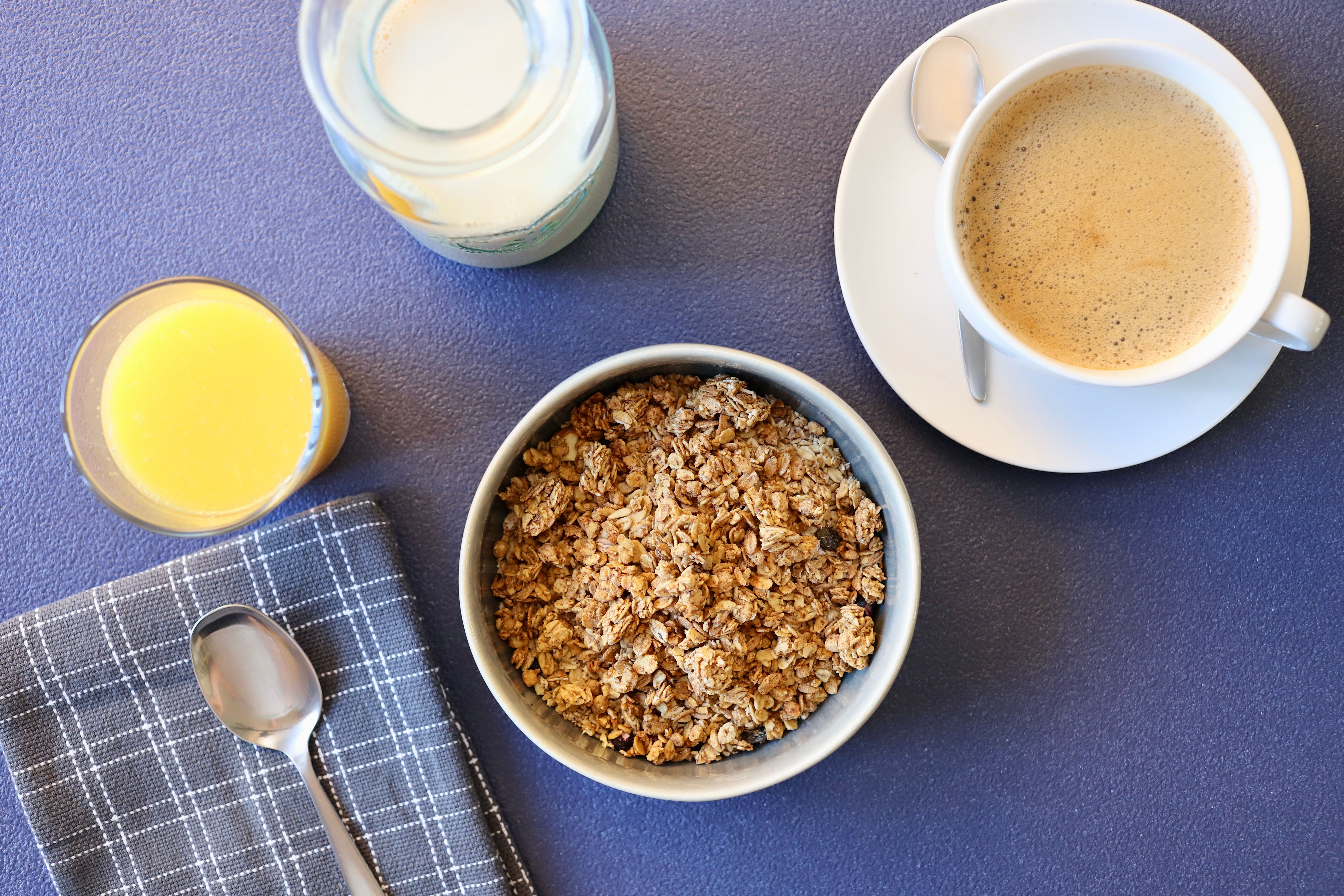 Top view of coffee, granola, and juice, perfect for a balanced breakfast.
