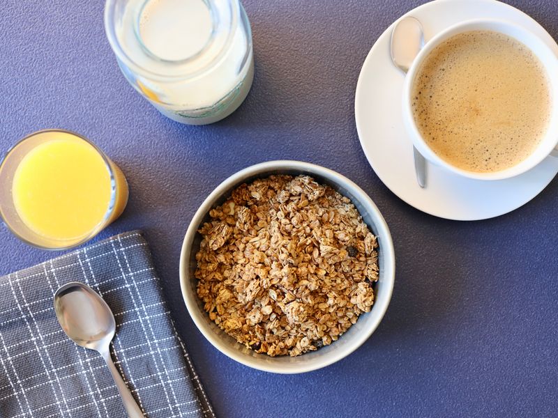 Top view of coffee, granola, and juice, perfect for a balanced breakfast.