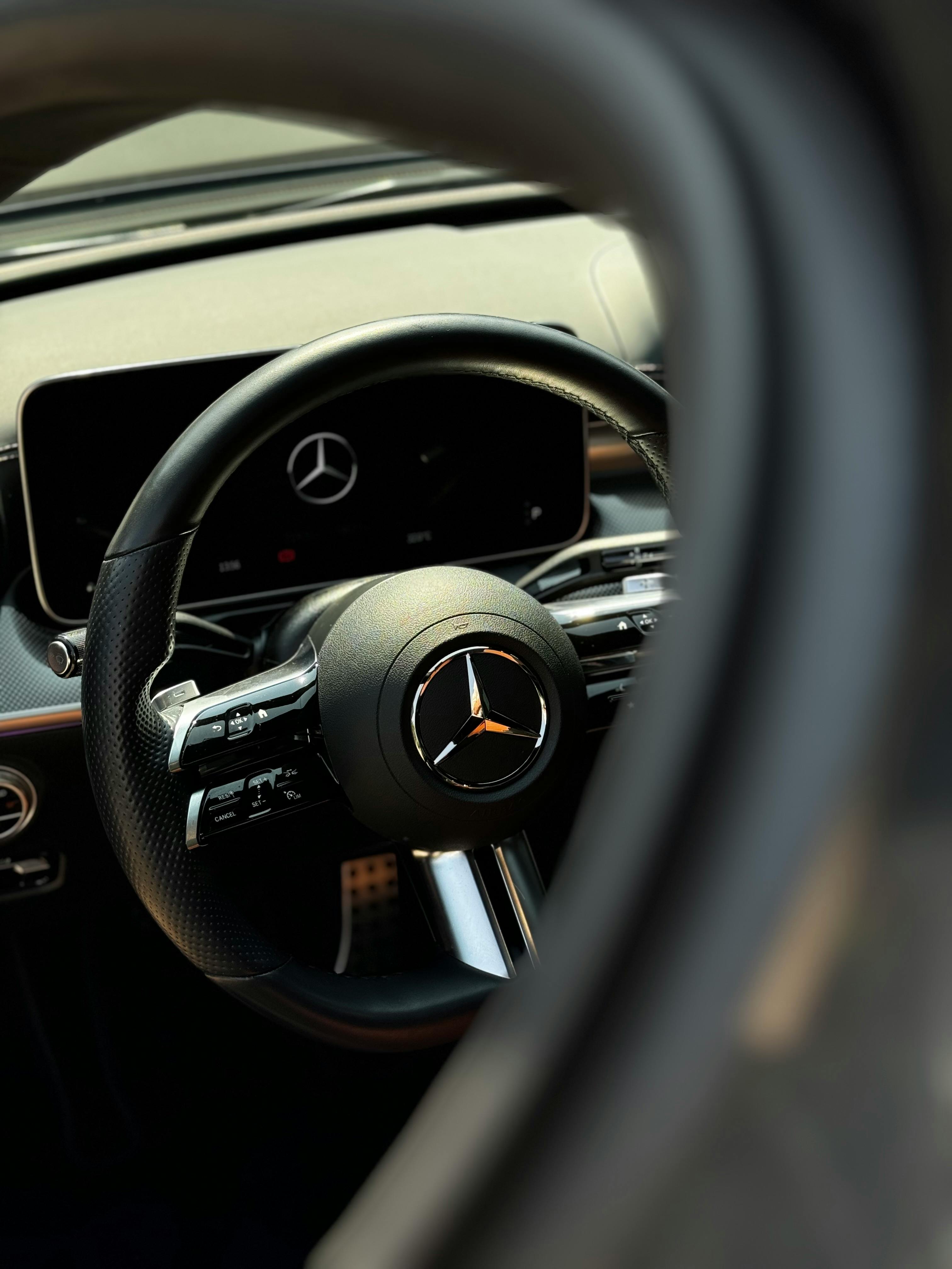 the interior of a mercedes benz car with a steering wheel