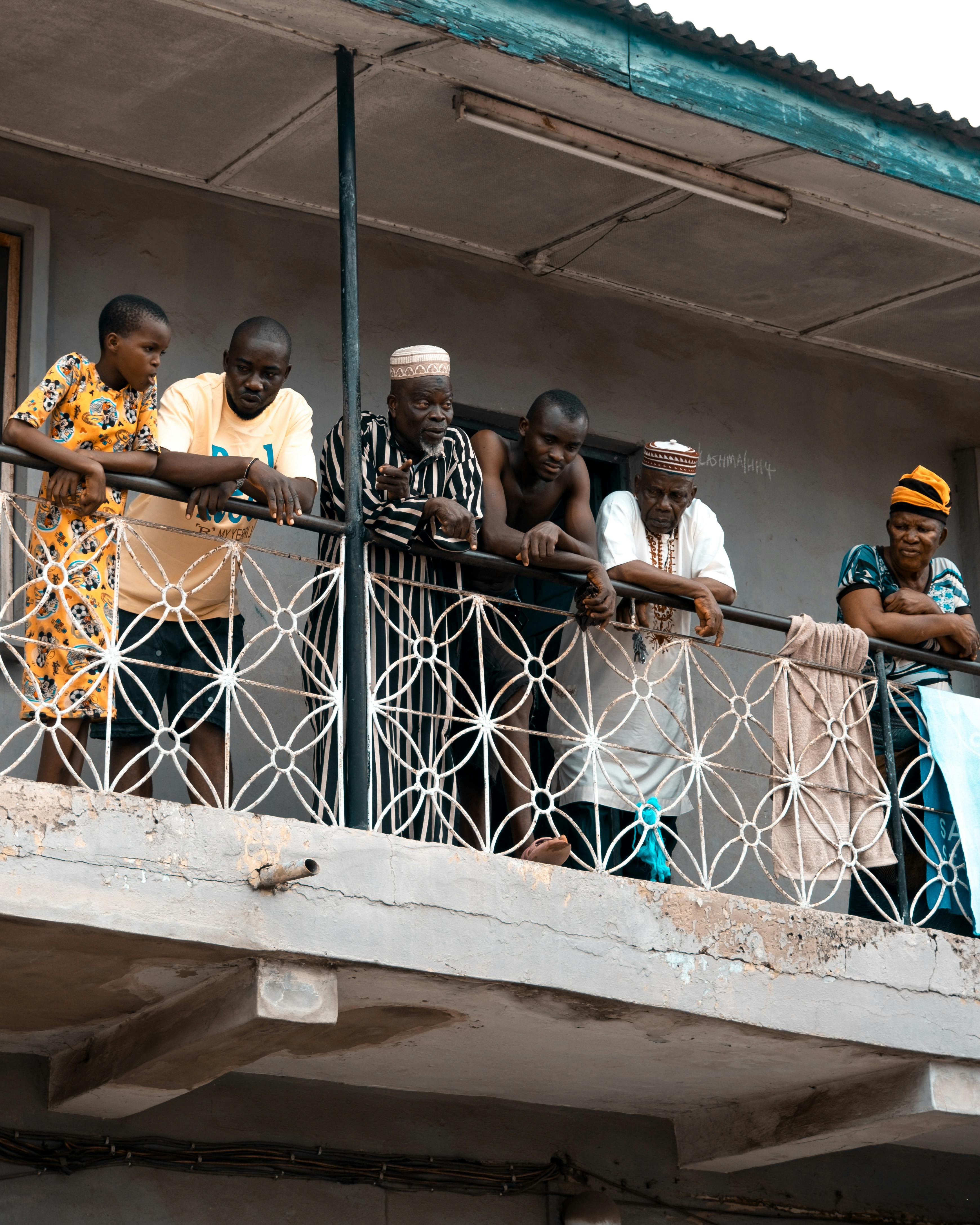 a group of people on a balcony looking out