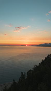 Mesmerizing sunset view over the Pacific Ocean with serene waters and vibrant skies in Vancouver, Canada.