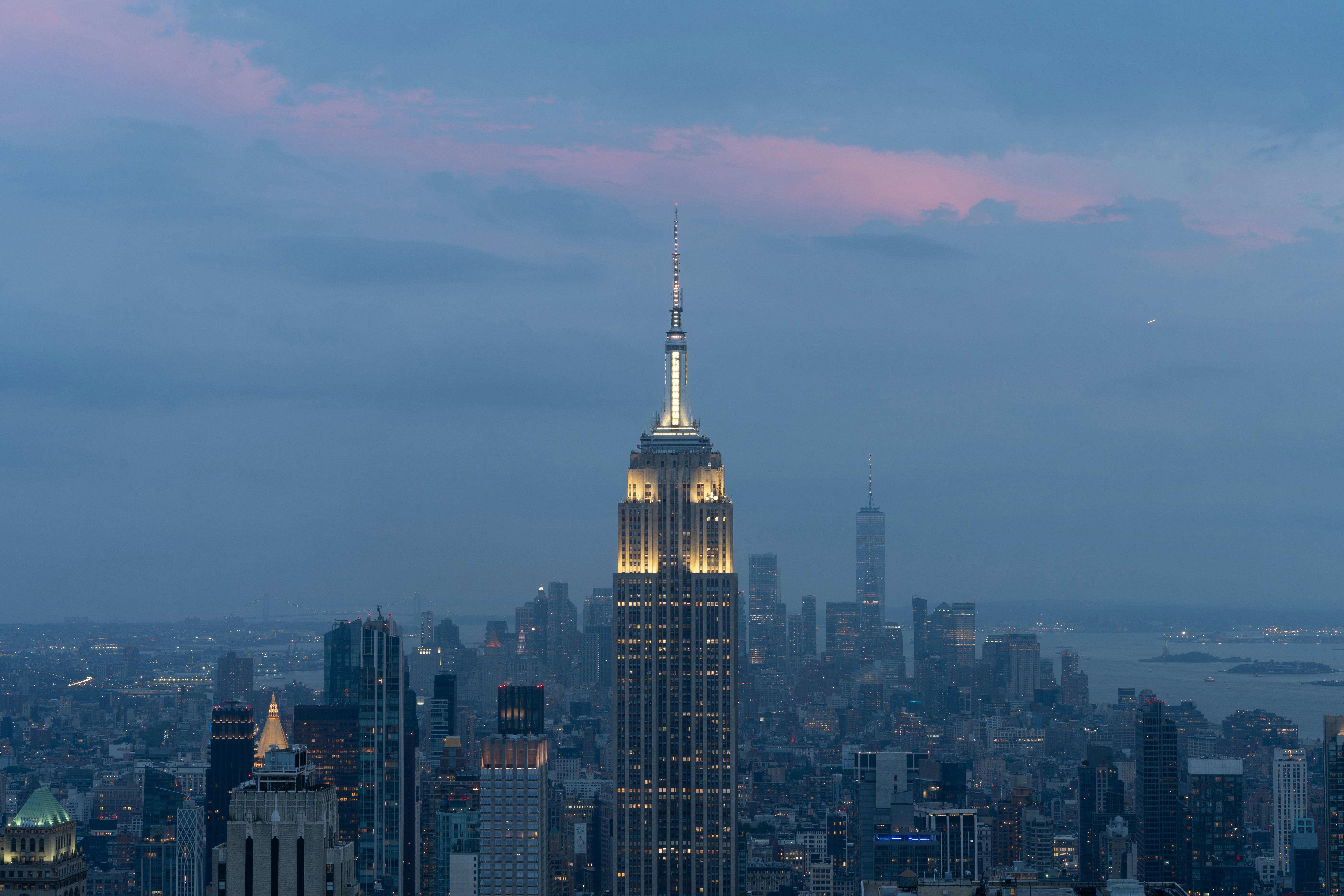 Iconic New York skyline featuring the Empire State Building at twilight with a vibrant sky