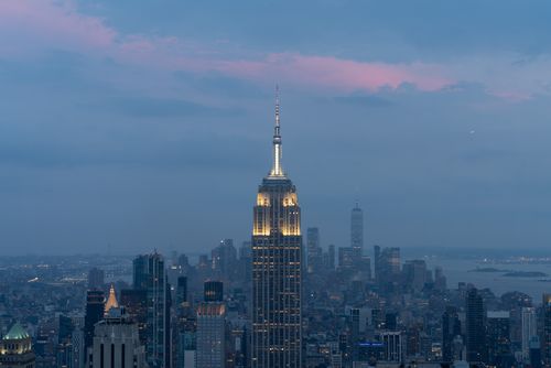 Empire State Building lit against a twilight sky in the New York skyline