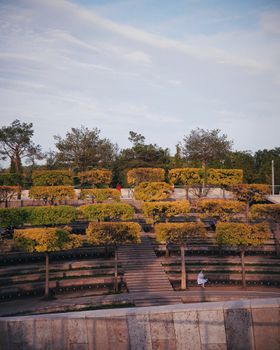 Scenic view of a landscaped park with terraced gardens and walking paths.