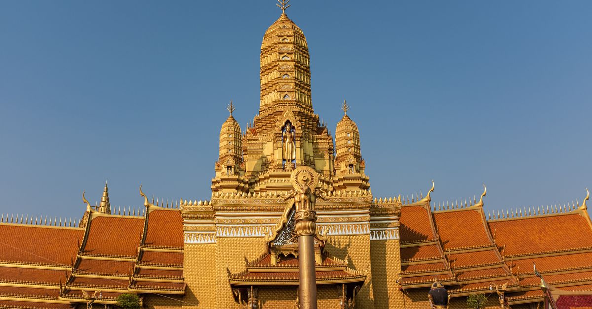 Temple in Southeast Asia surrounded by lush tropical greenery