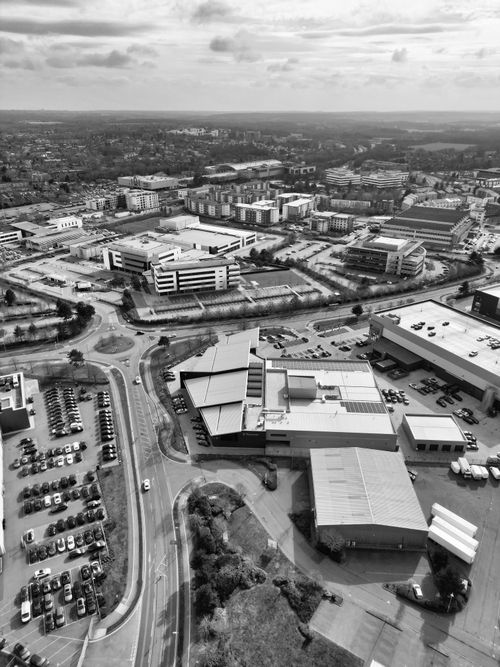 Free Black and white aerial view of Hertfordshire's industrial area showcasing urban layout. Stock Photo