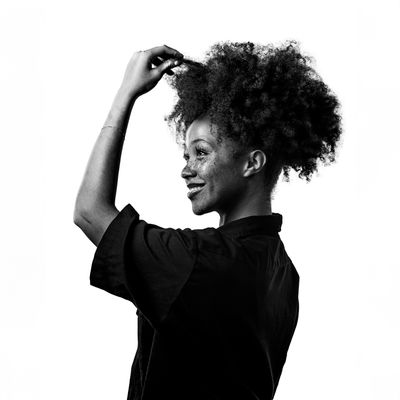 Portrait of a joyful woman with curly hair — photo by Seats Photographix on Pexels