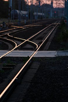 Railway tracks in Wrocław at sunset, showcasing intricate rail infrastructure and urban design.
