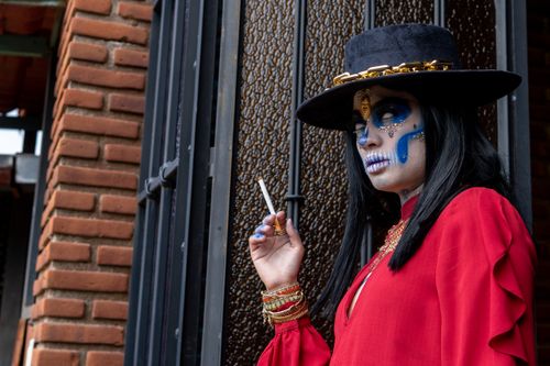 Free A woman in vibrant calavera makeup celebrating Dia de los Muertos in Mexico City. Stock Photo