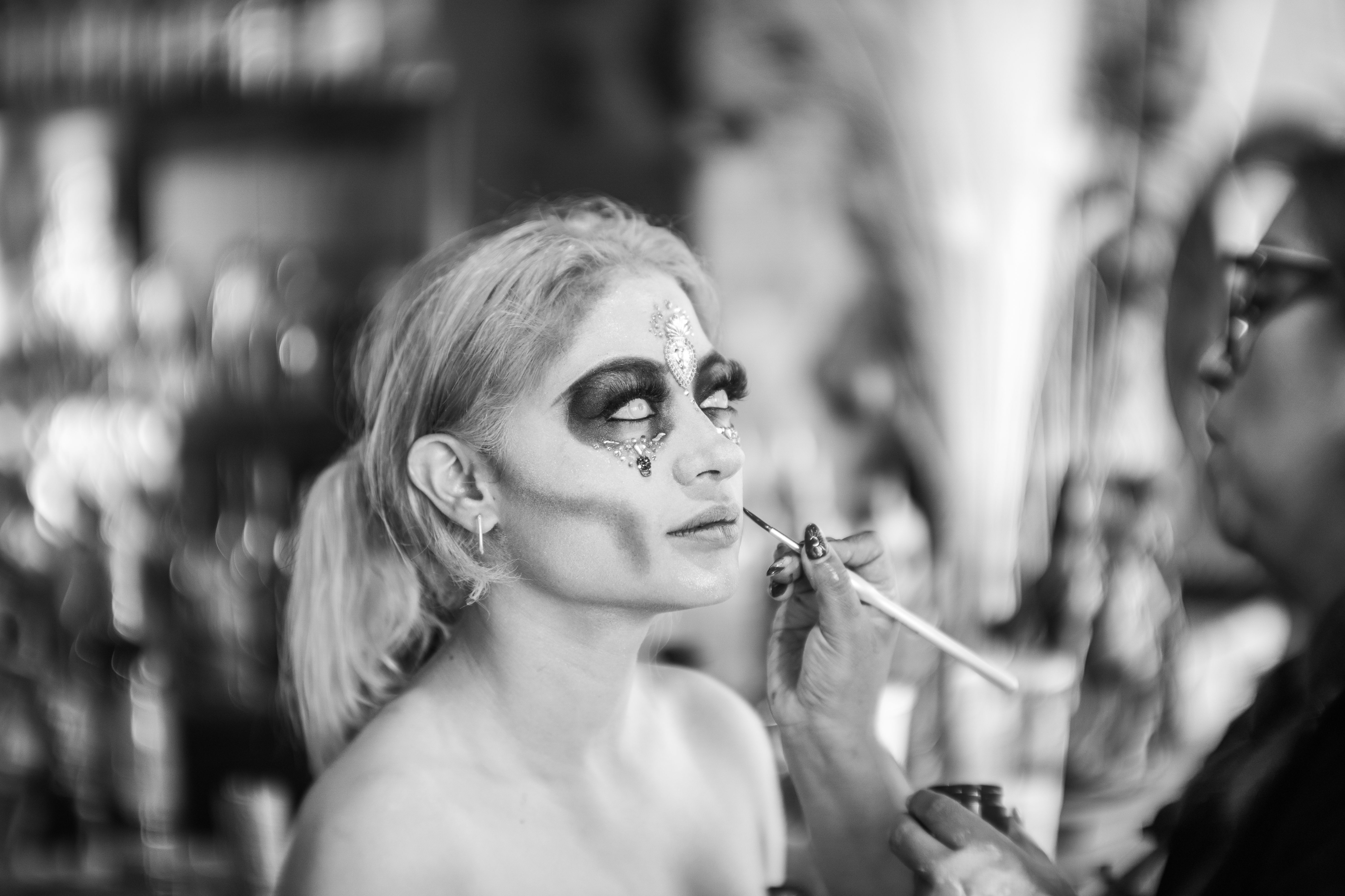 Black and white photo of a Day of the Dead makeup session in Mexico City.