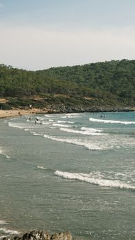 An idyllic beach scene with gentle waves and lush greenery, perfect for travel and relaxation.