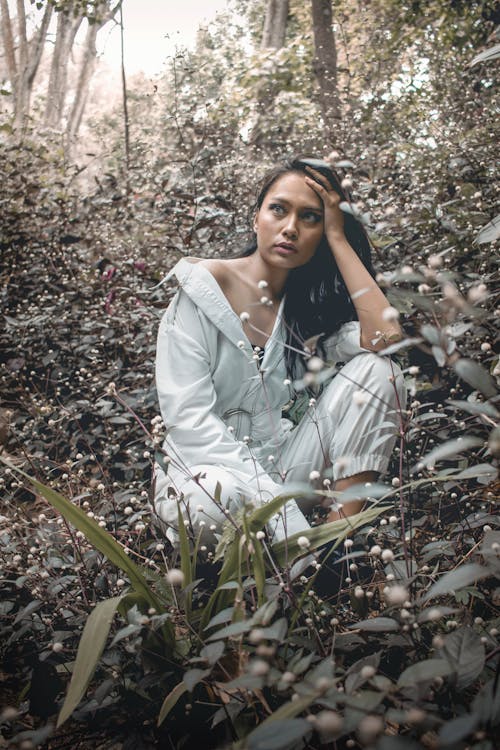 Woman Sitting Near Plants