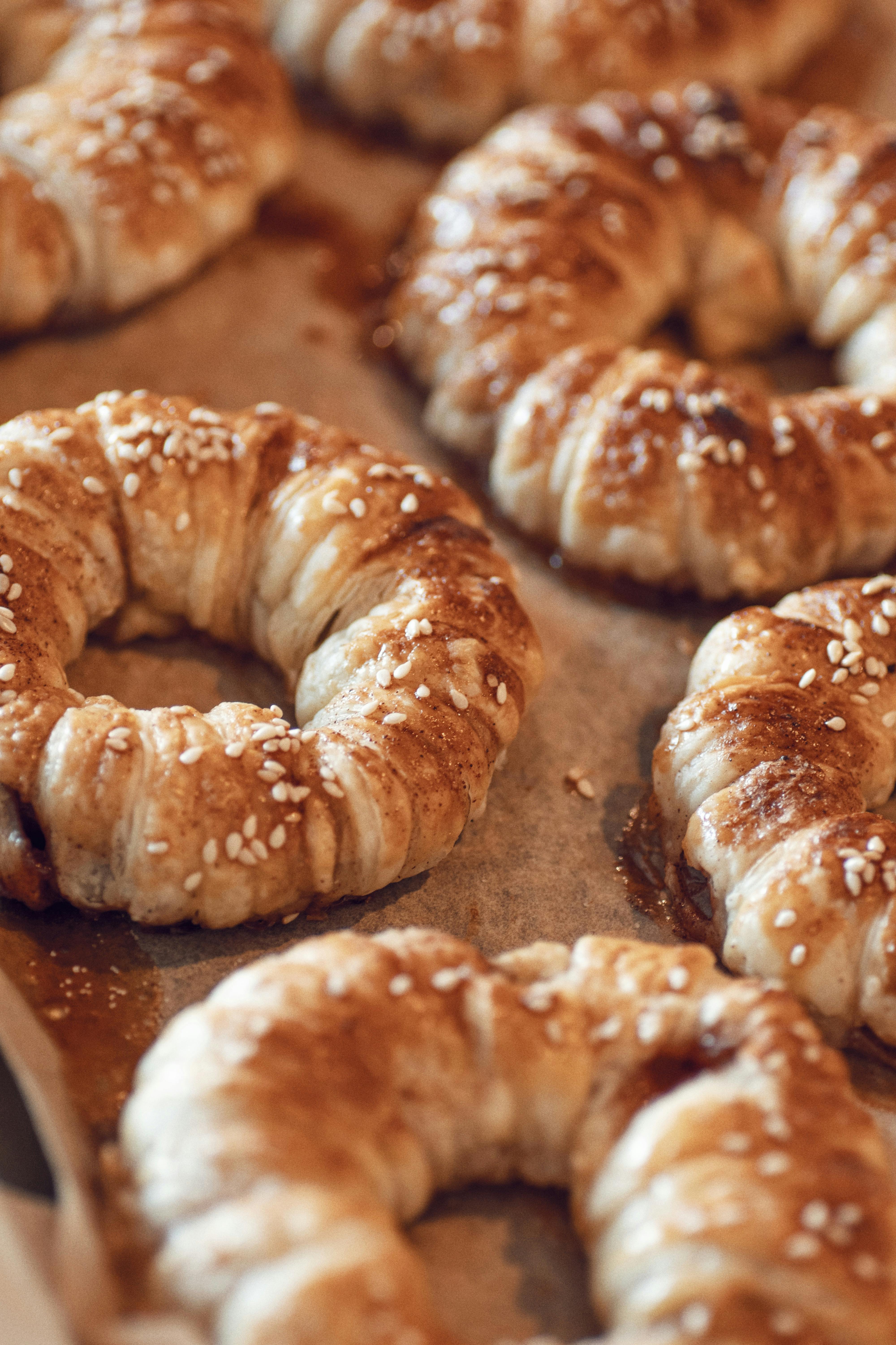 Scrumptious sesame-topped pastry rings fresh out of the oven, perfect for a sweet treat.