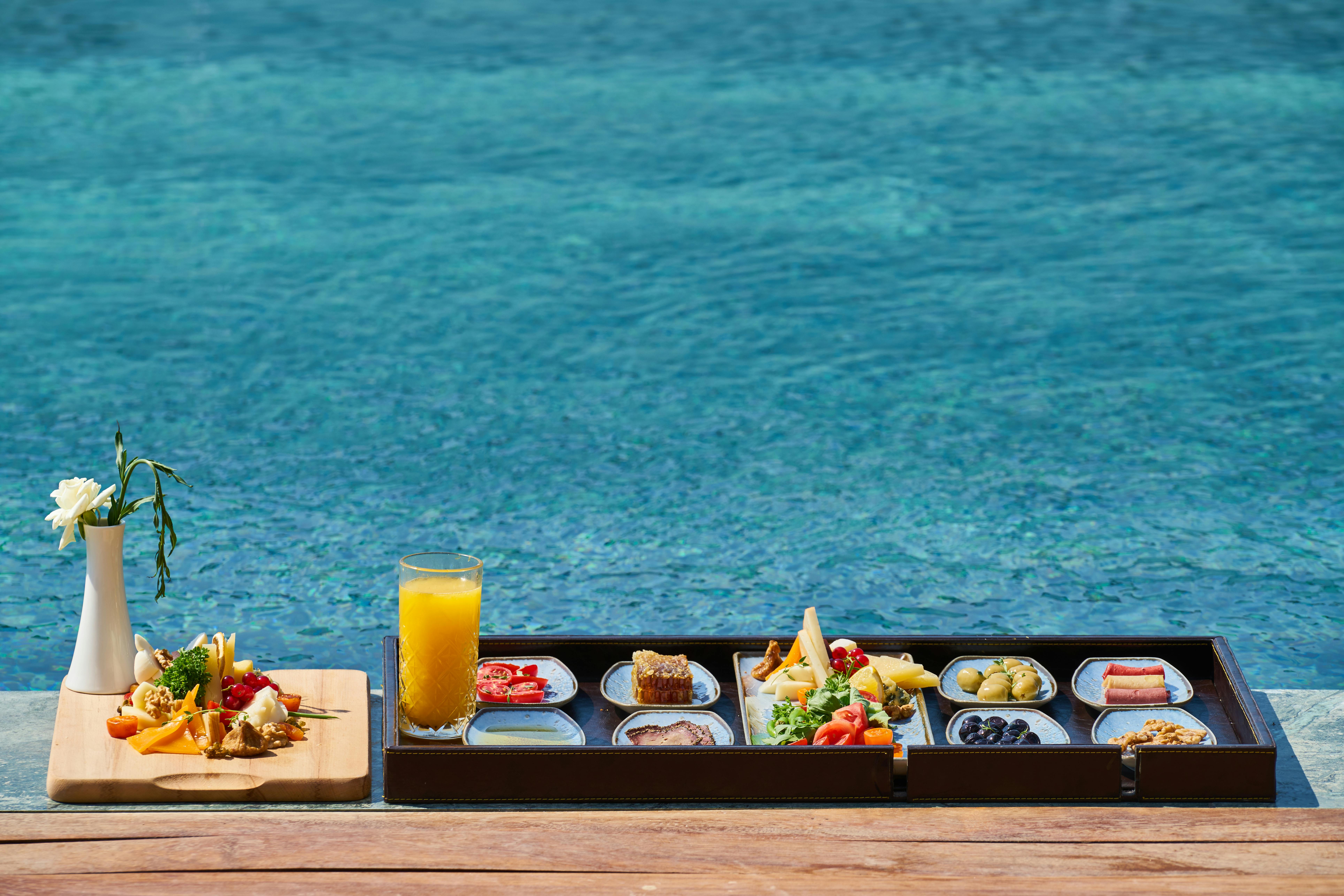Tray of Food Beside Body of Water