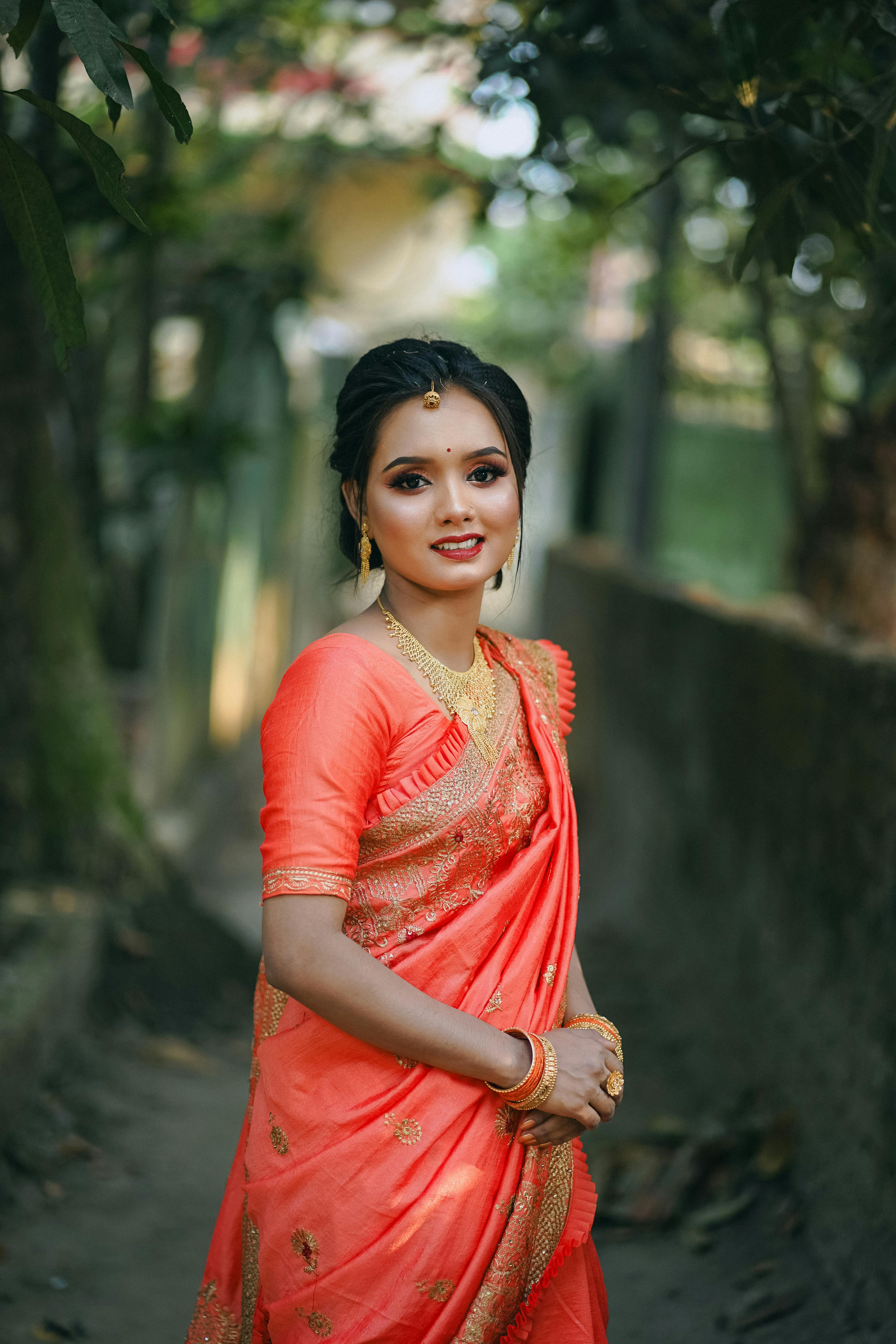 a beautiful woman in an orange sari