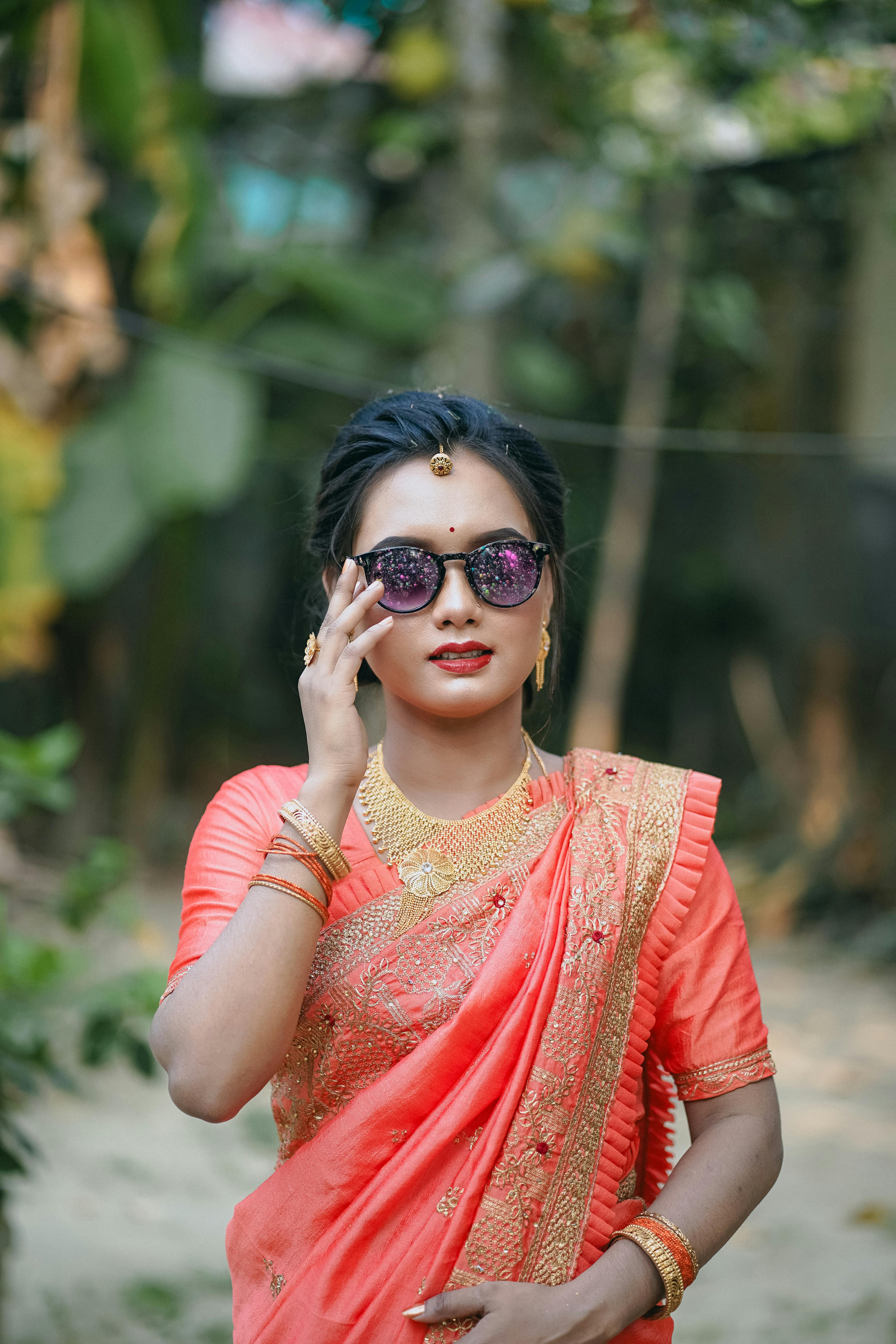 a woman in a sari and sunglasses