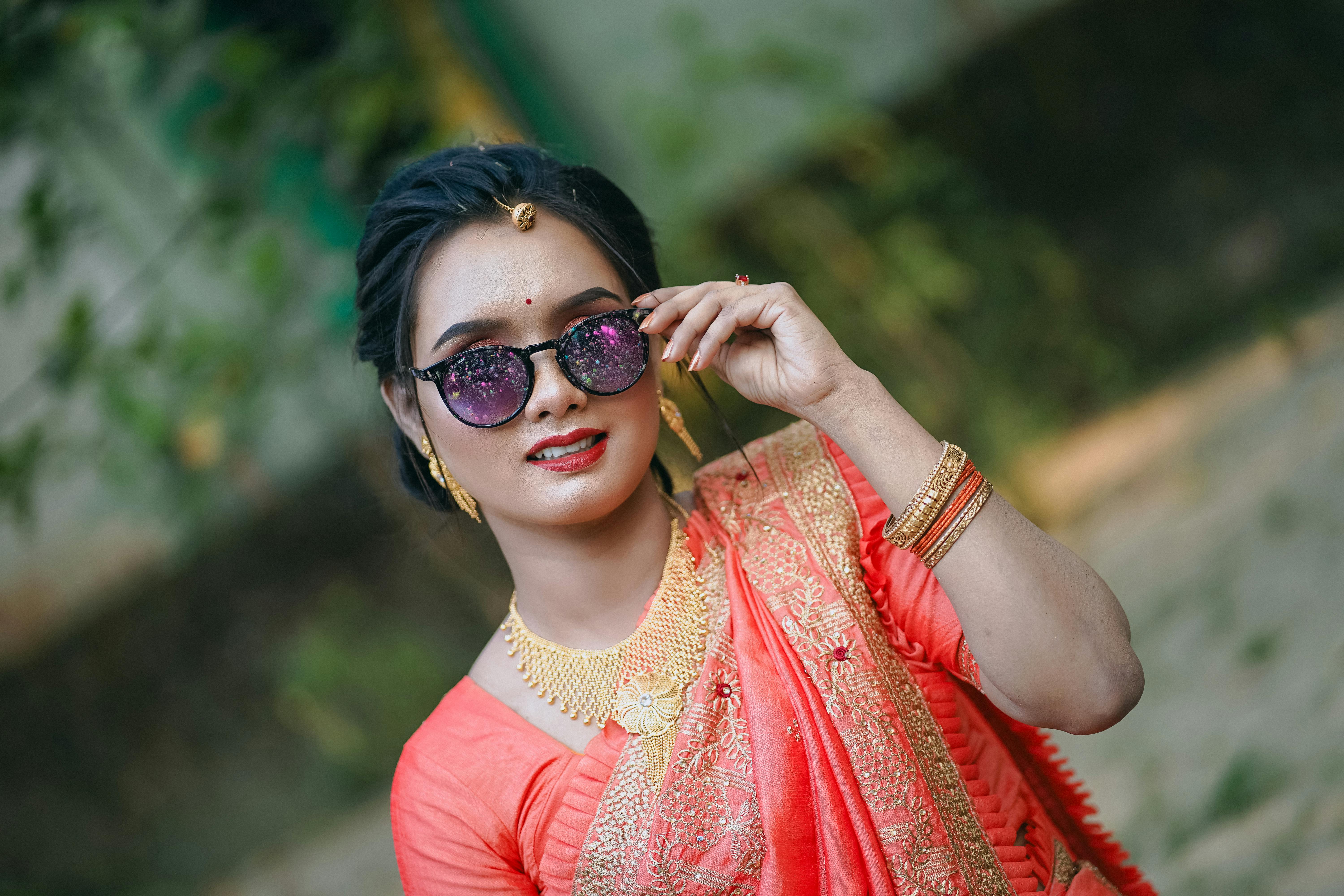 a woman in a sari and sunglasses