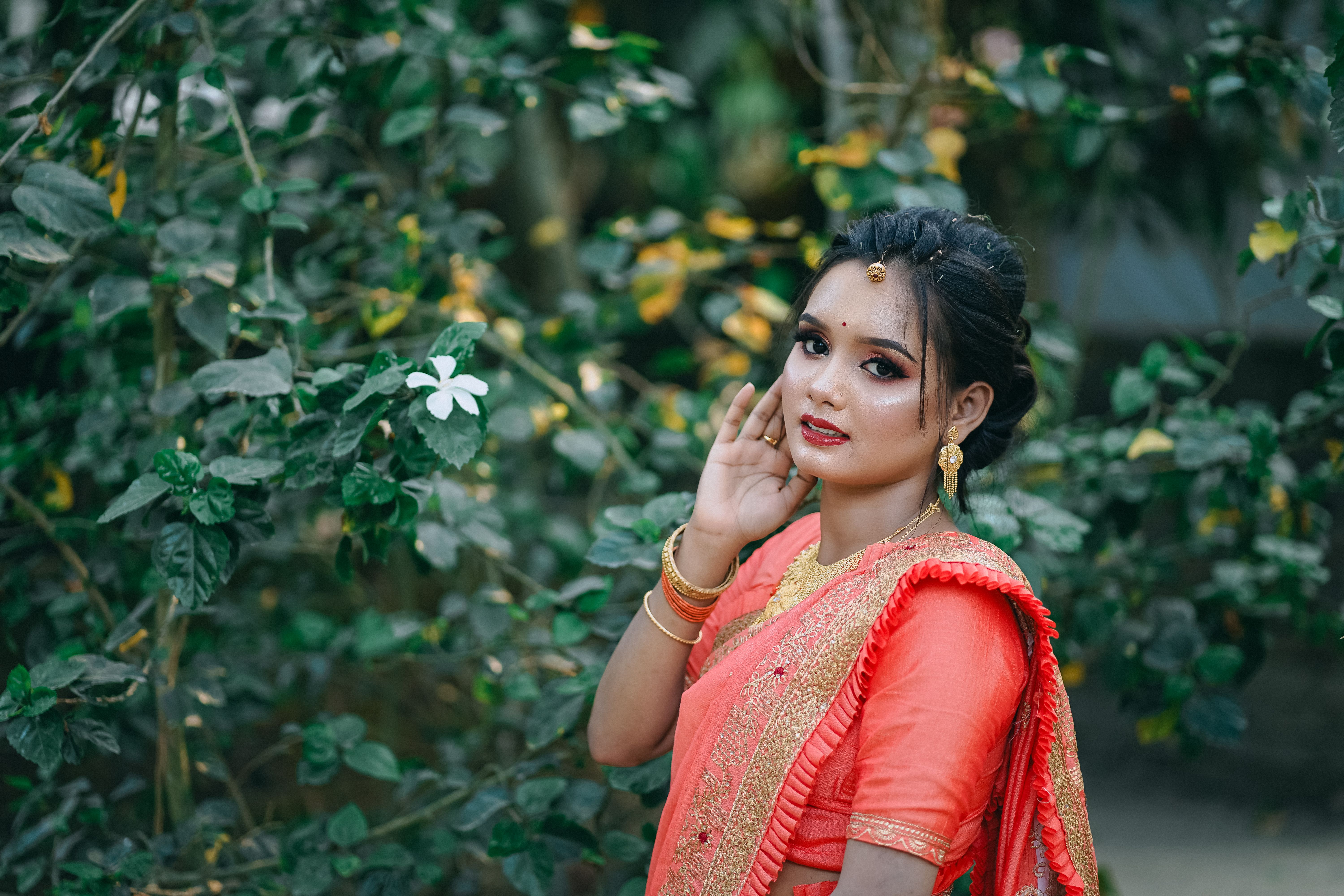 A beautiful woman in an orange sari posing for the camera · Free Stock ...