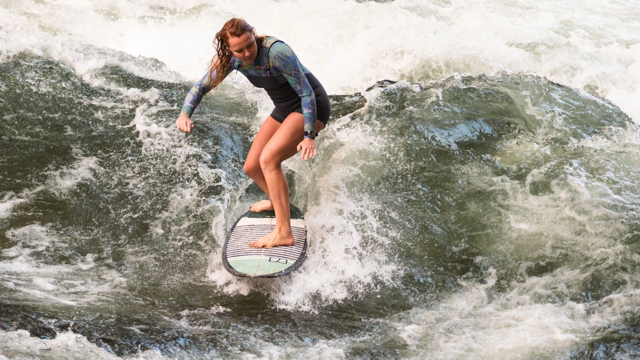 Surfboard Riding A woman riding a surfboard on a wave · Free Stock Photo