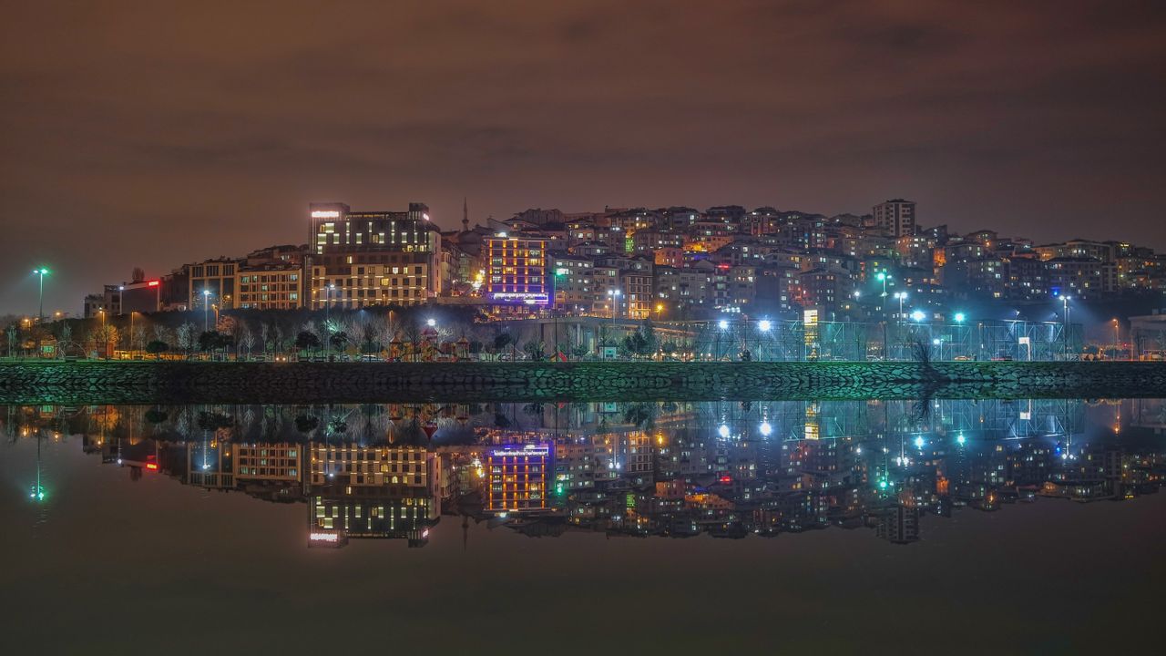 vivid cityscape at night with colorful building lights reflecting on a