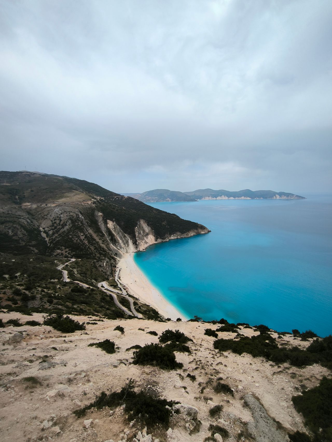 A stunning aerial view of Myrtos Beach's turquoise waters and dramatic cliffs in Kefalonia, Greece.