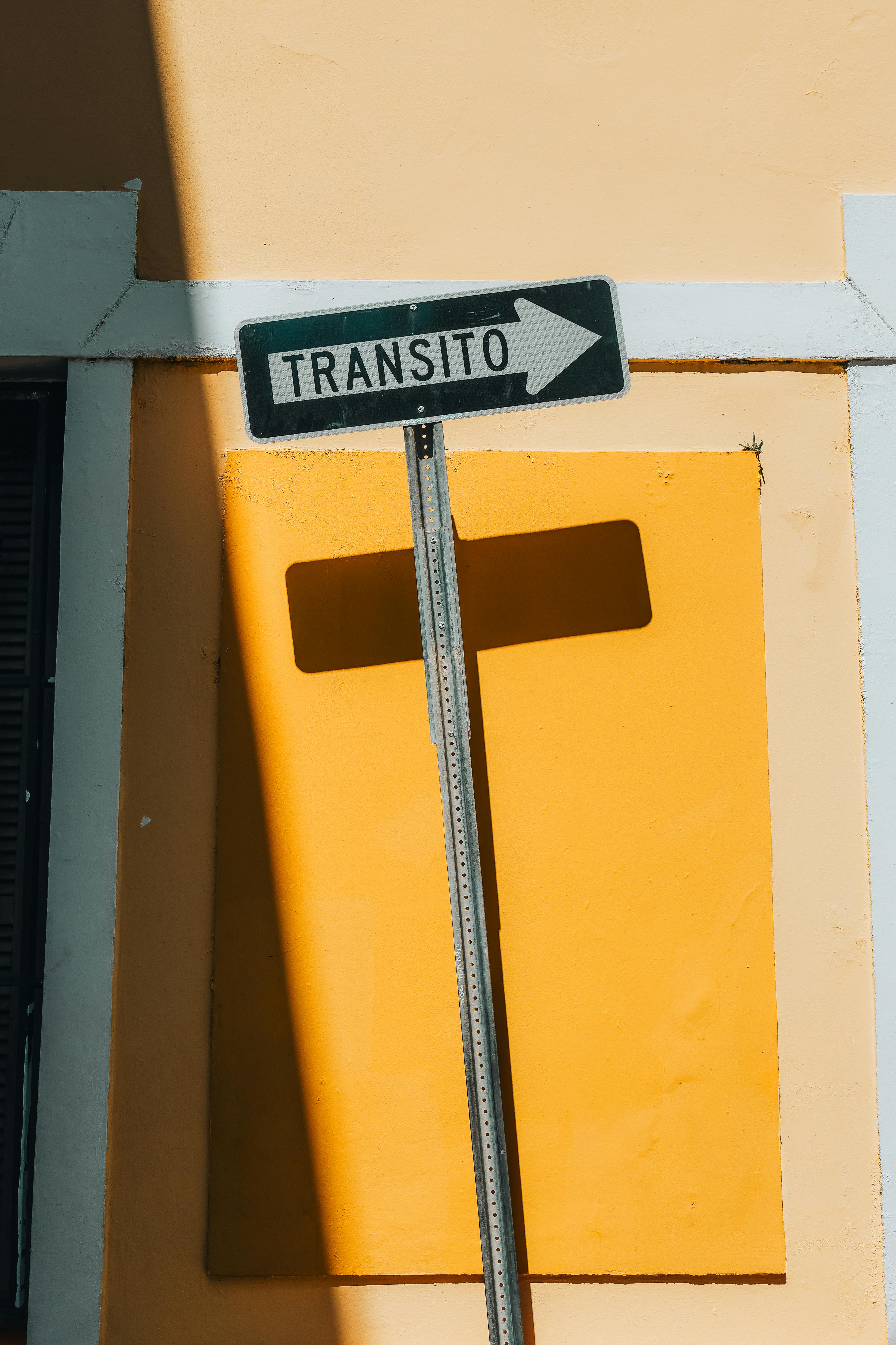 A street sign casting shadows on a colorful wall in San Juan, Puerto Rico