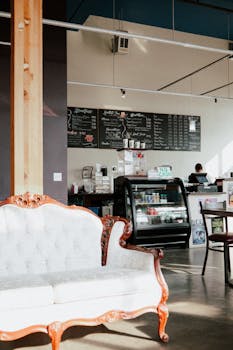 Modern coffee shop in Seattle featuring a vintage Victorian sofa and stylish decor.